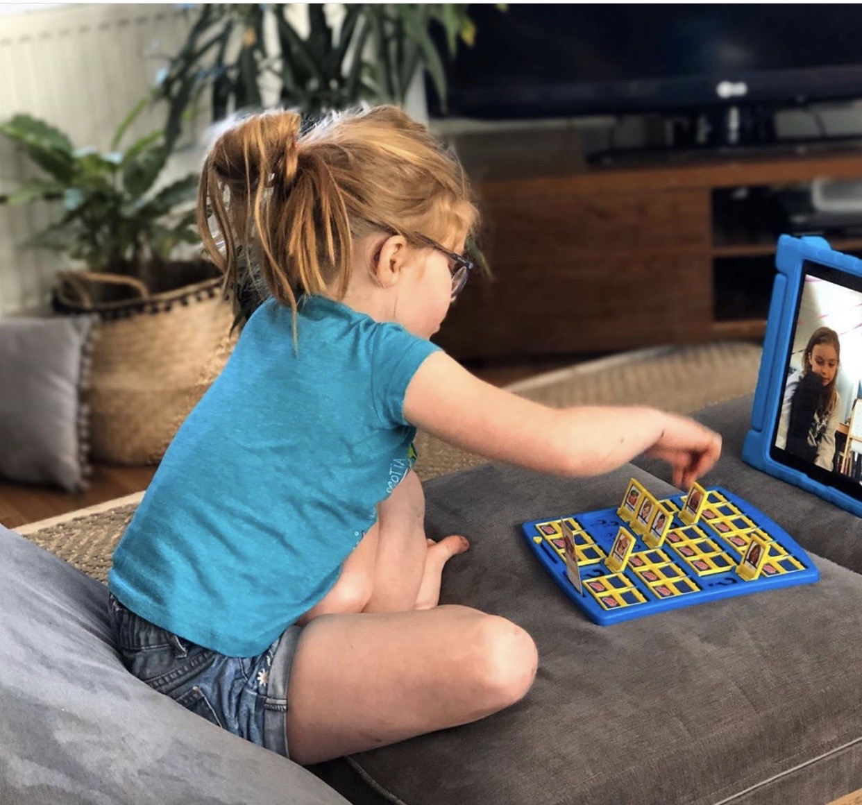 Little girl playing Guess Who on Zoom